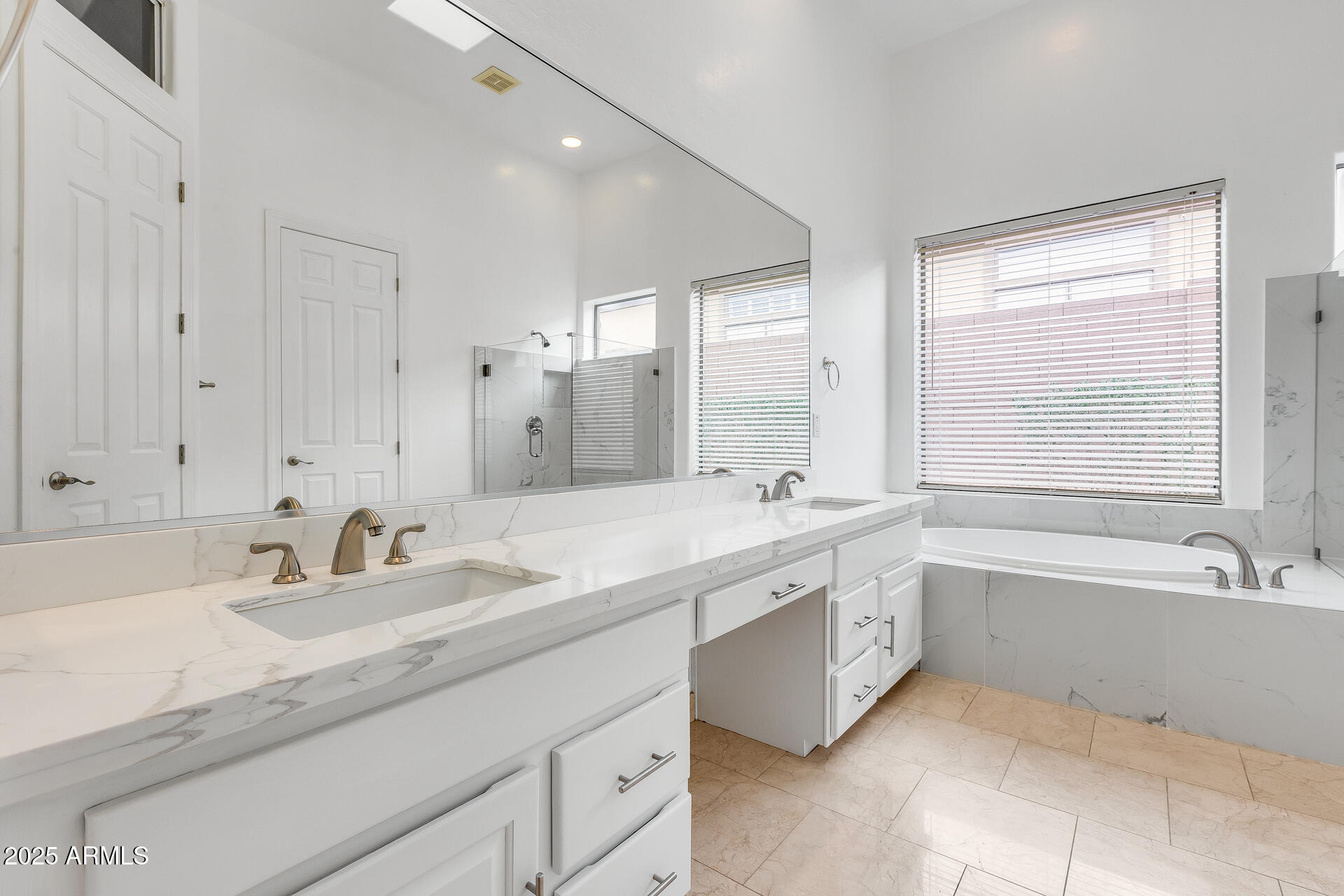 3138 West Ravina Lane Anthem, AZ 85086 - Photo 18 of 38 a bathroom with a sink double vanity granite tub shower and a mirror