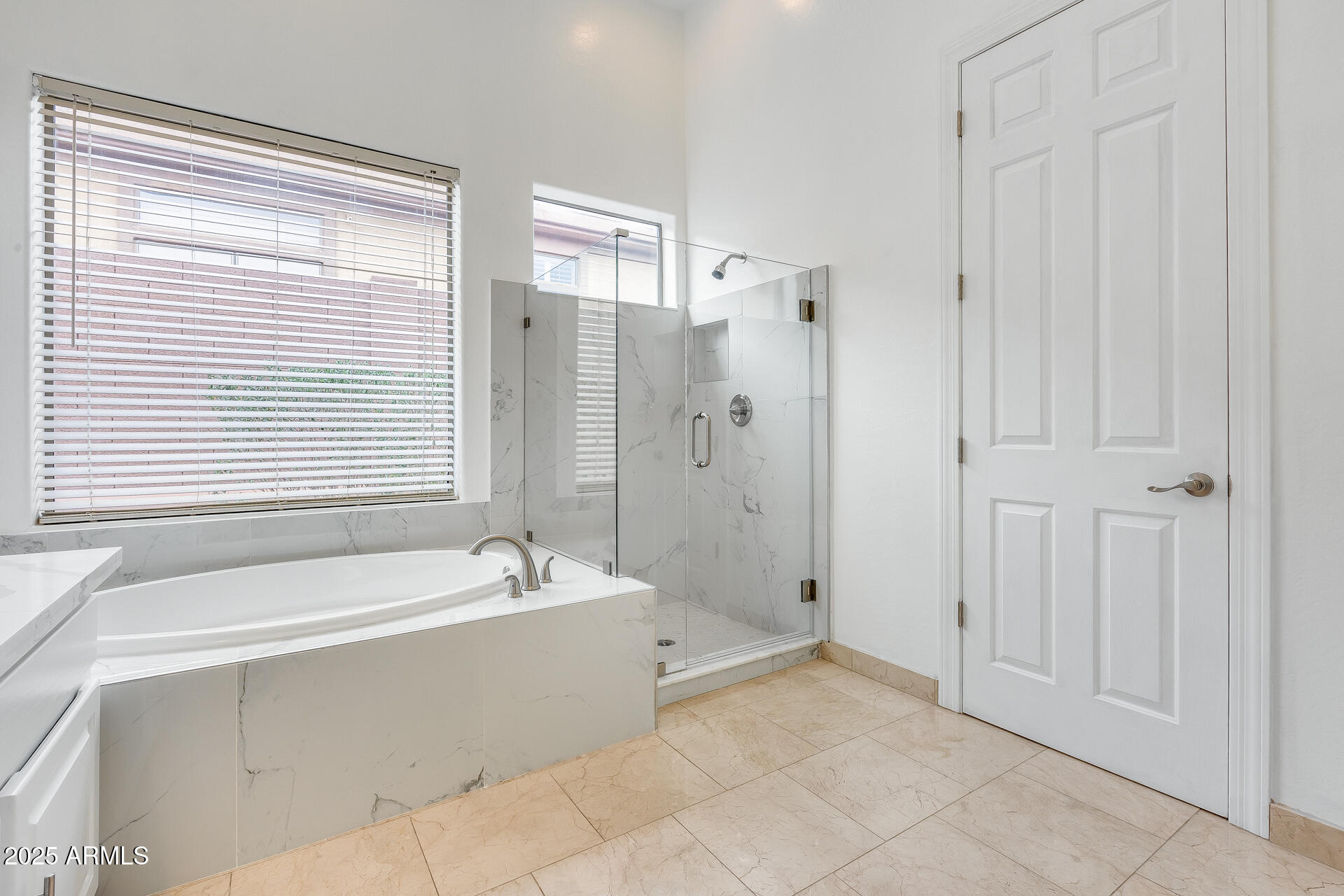 3138 West Ravina Lane Anthem, AZ 85086 - Photo 19 of 38 a spacious bathroom with a bathtub and a shower