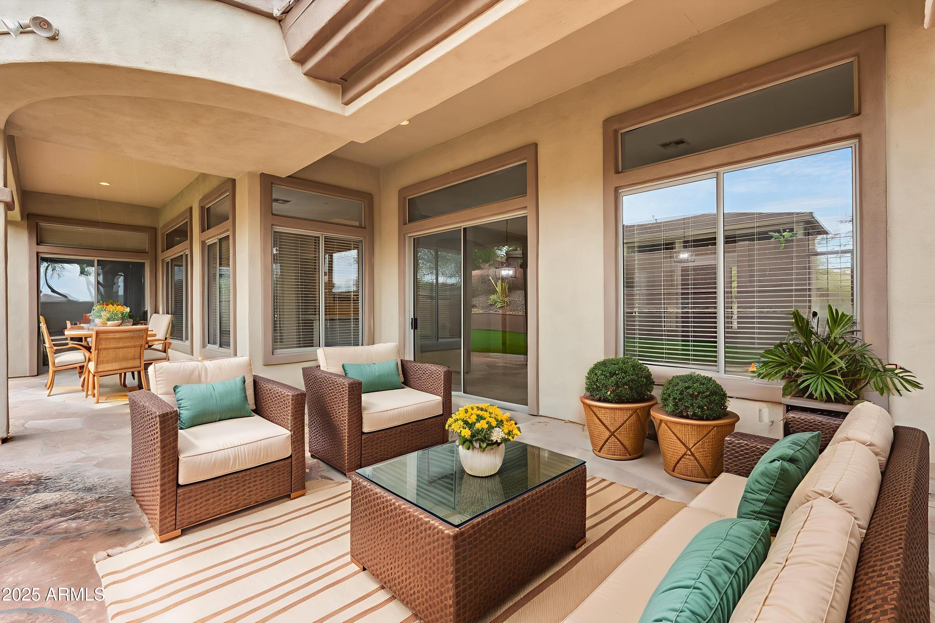 3138 West Ravina Lane Anthem, AZ 85086 - Photo 21 of 38 a outdoor living space with furniture and a potted plant