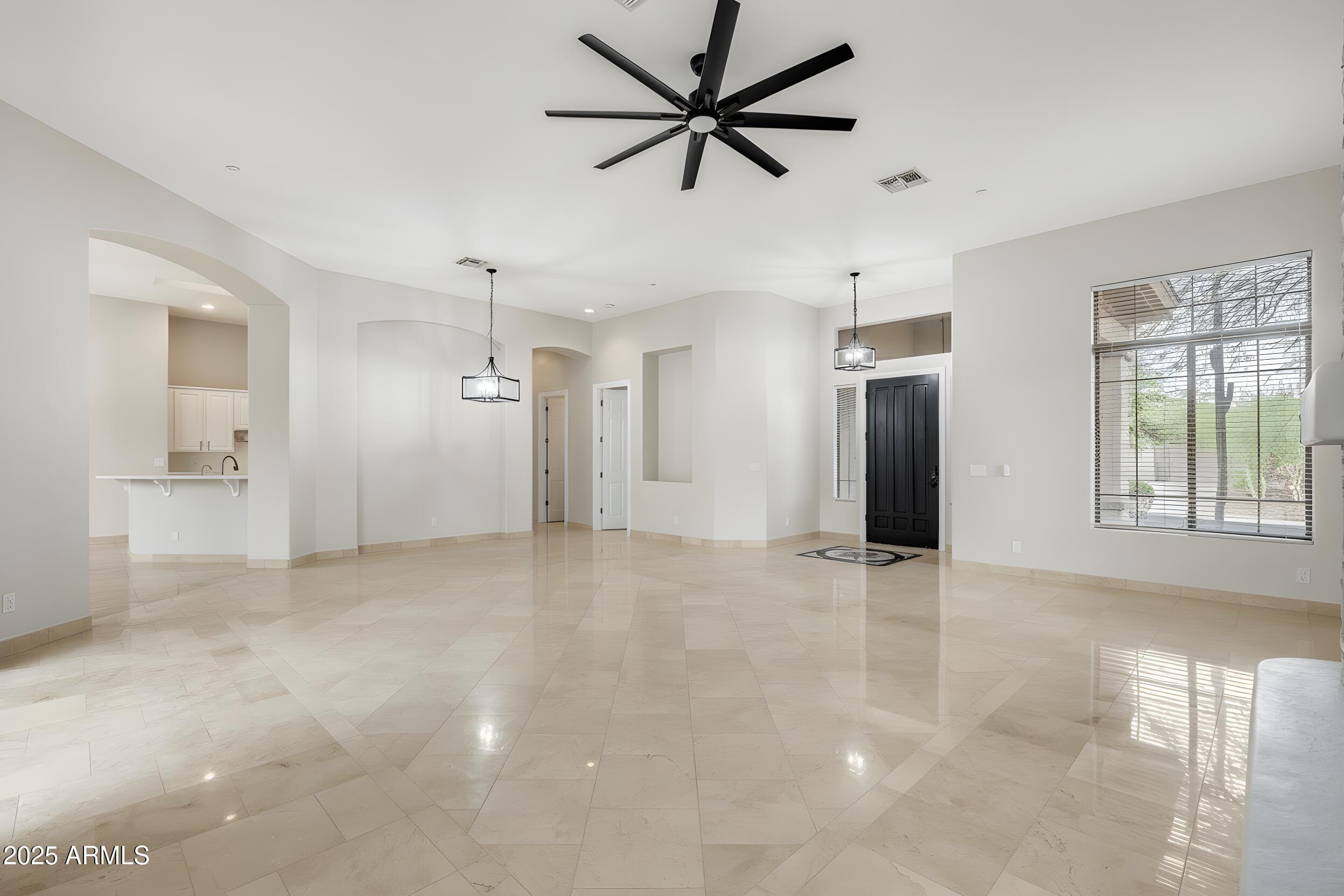 3138 West Ravina Lane Anthem, AZ 85086 - Photo 4 of 38 a view of an empty room with a window