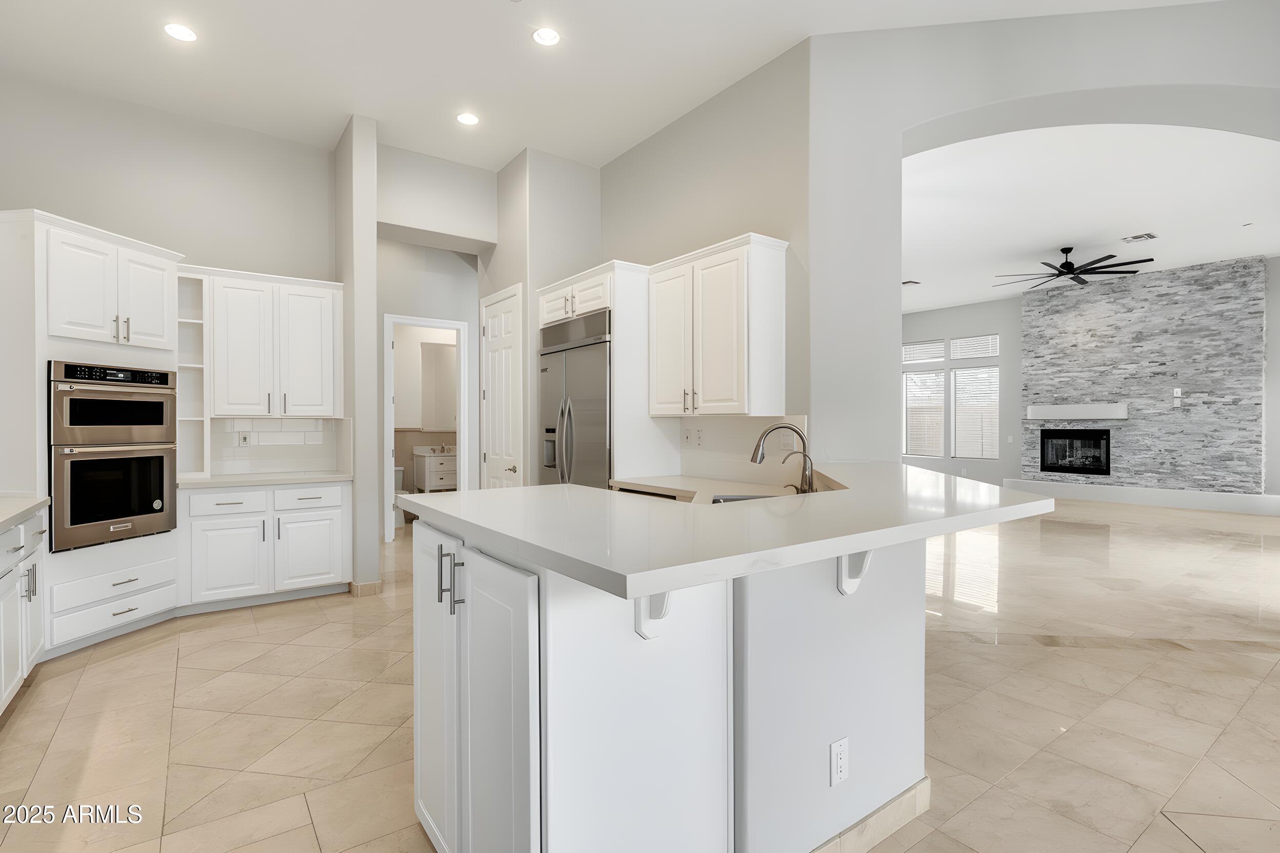 3138 West Ravina Lane Anthem, AZ 85086 - Photo 8 of 38 a kitchen with stainless steel appliances granite countertop a sink and cabinets