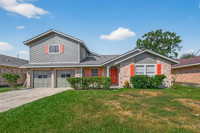 a front view of house with yard and green space
