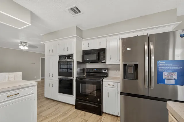 a kitchen with stainless steel appliances a refrigerator stove and sink