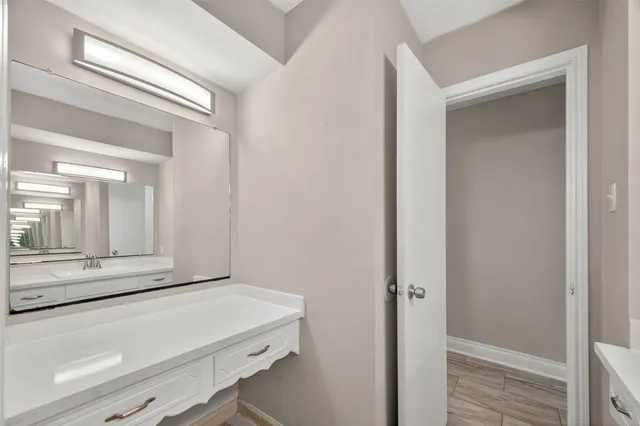 a room with a wooden floor and vanity