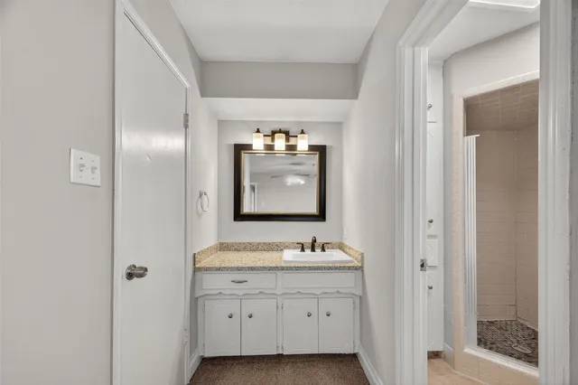 a bathroom with a sink double vanity and a mirror