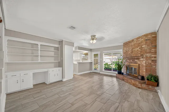 wooden floor in an empty room with a fireplace