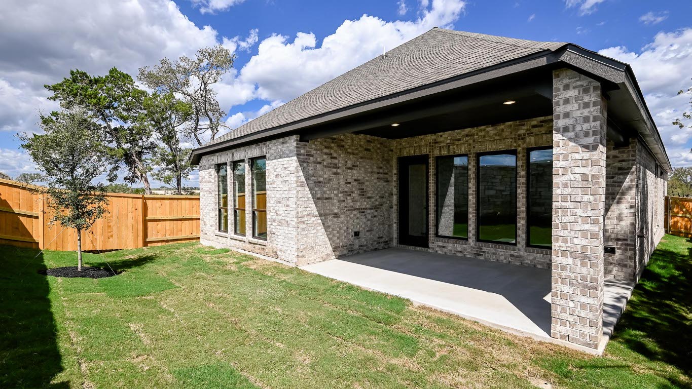 175 High Rock Pass Kyle, TX 78640 - Photo 17 of 39 Back of property featuring brick siding, a patio, and a shingled roof