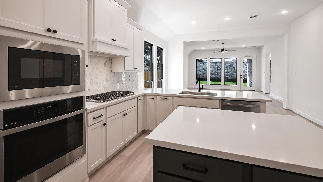 175 High Rock Pass Kyle, TX 78640 - Photo 19 of 39 Kitchen with appliances with stainless steel finishes, light wood-type flooring, backsplash, white cabinets, and recessed lighting