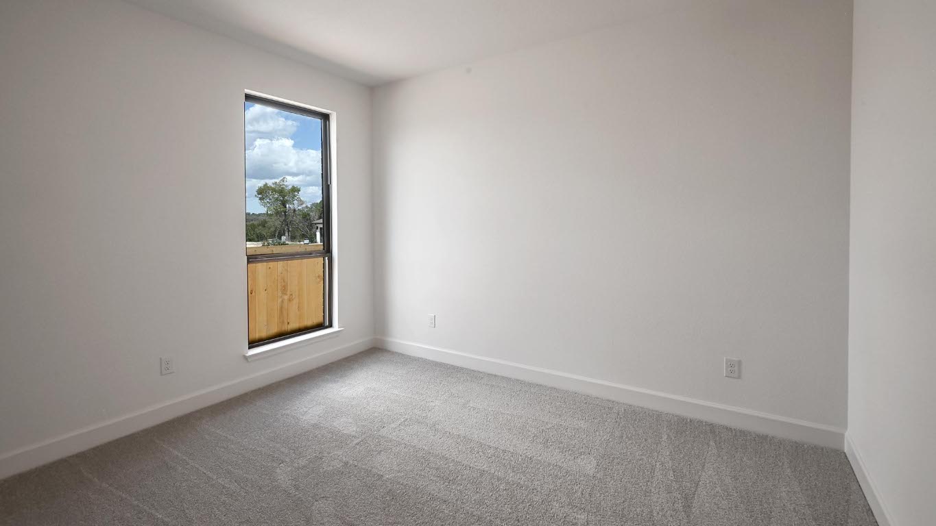 175 High Rock Pass Kyle, TX 78640 - Photo 20 of 39 Carpeted empty room featuring baseboards