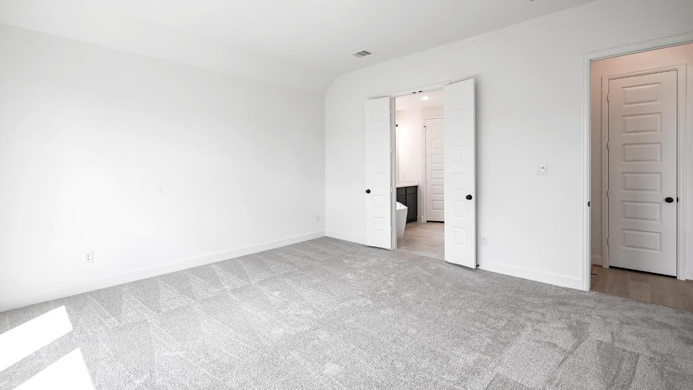 175 High Rock Pass Kyle, TX 78640 - Photo 22 of 39 Unfurnished bedroom featuring ensuite bathroom and carpet