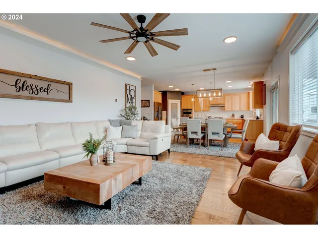 a living room with furniture and kitchen view