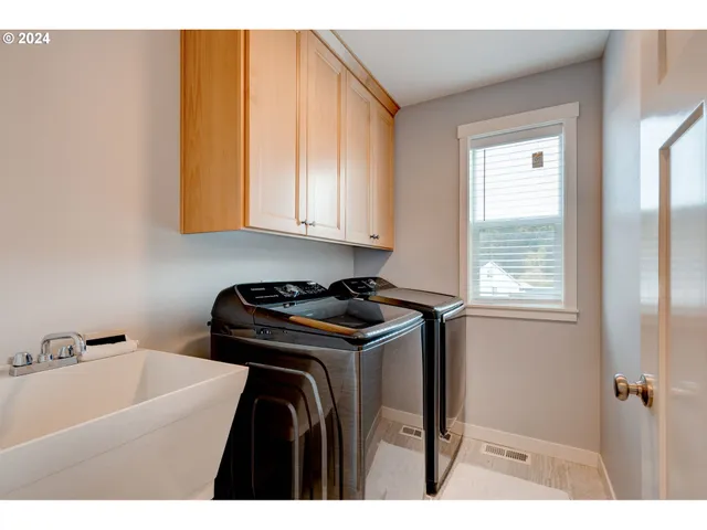 a utility room with closet dryer and washer