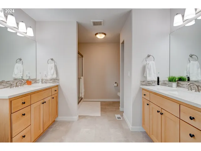 a bathroom with a double vanity sink and a mirror