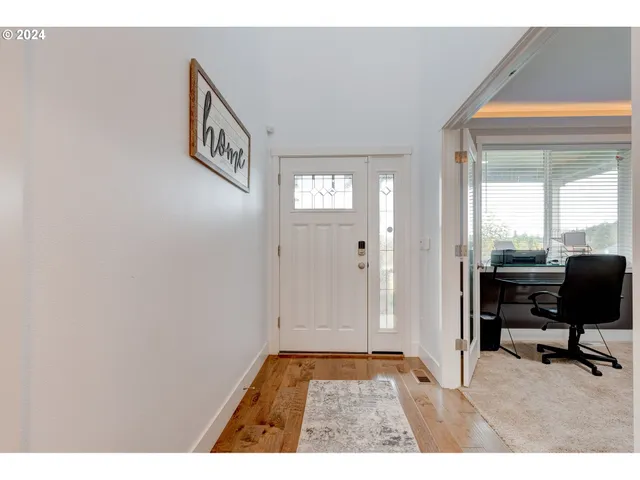 a view of a hallway and a livingroom with couch