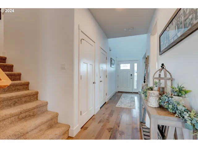 a view of entryway and hall with wooden floor