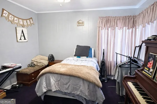 a bedroom with two beds and a window