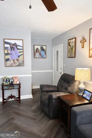 a living room with furniture and painting on the wall