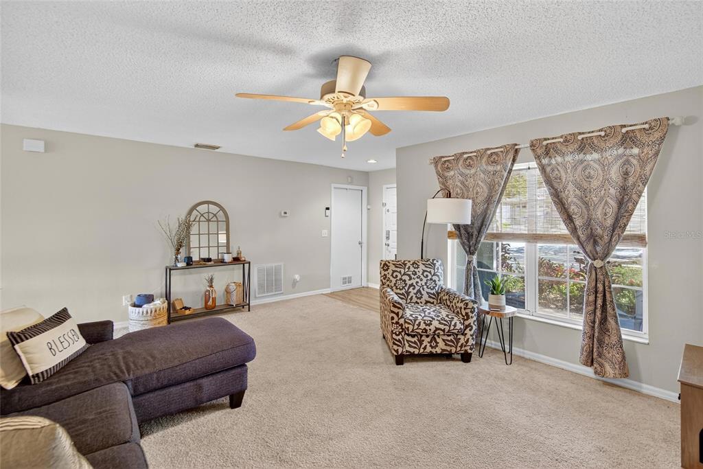 630 Cape Cod Circle Valrico, FL 33594 - Photo 11 of 48 a living room with furniture a window and a chandelier