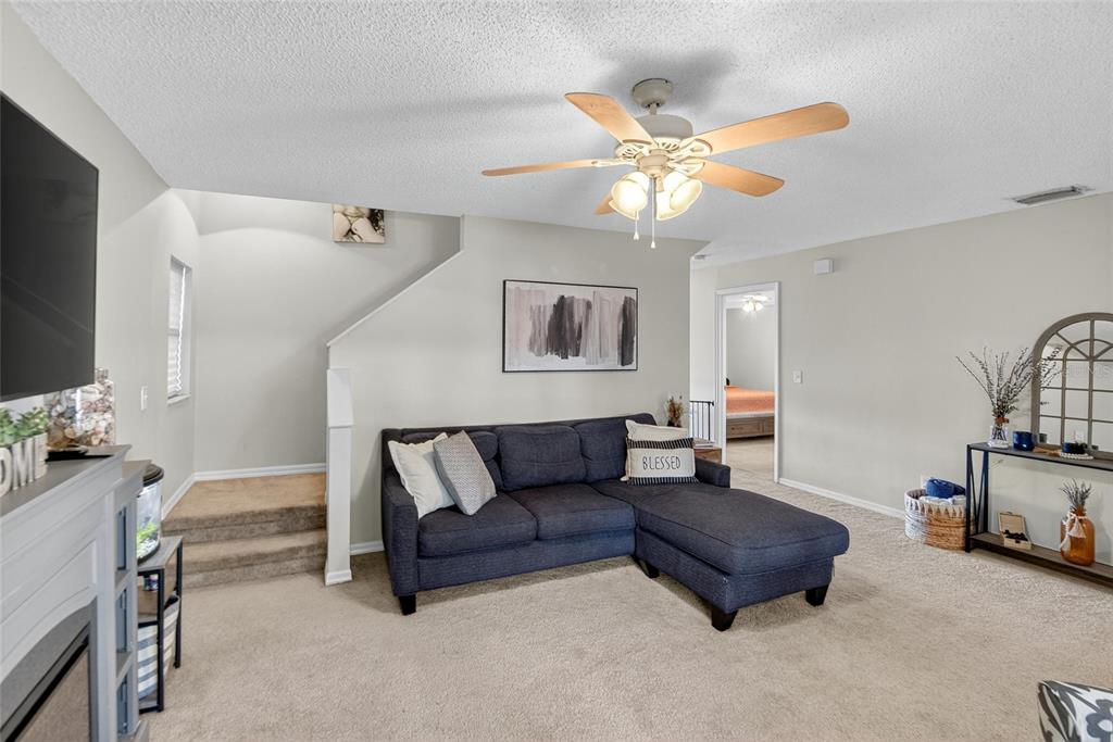 630 Cape Cod Circle Valrico, FL 33594 - Photo 12 of 48 a living room with furniture and a flat screen tv