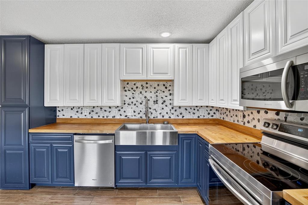 630 Cape Cod Circle Valrico, FL 33594 - Photo 17 of 48 a kitchen with stainless steel appliances a stove a sink and a microwave