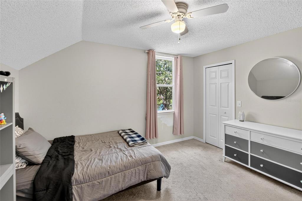 630 Cape Cod Circle Valrico, FL 33594 - Photo 27 of 48 a bedroom with a bed and a chandelier