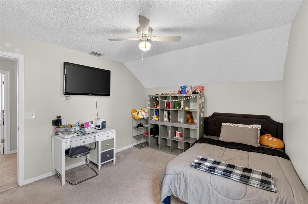 630 Cape Cod Circle Valrico, FL 33594 - Photo 28 of 48 a bedroom with furniture and a flat screen tv