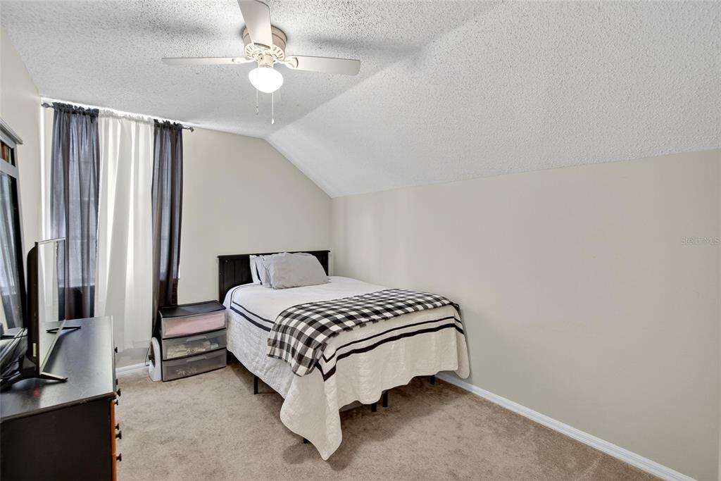 630 Cape Cod Circle Valrico, FL 33594 - Photo 30 of 48 a bedroom with a bed lamp and a flat screen tv