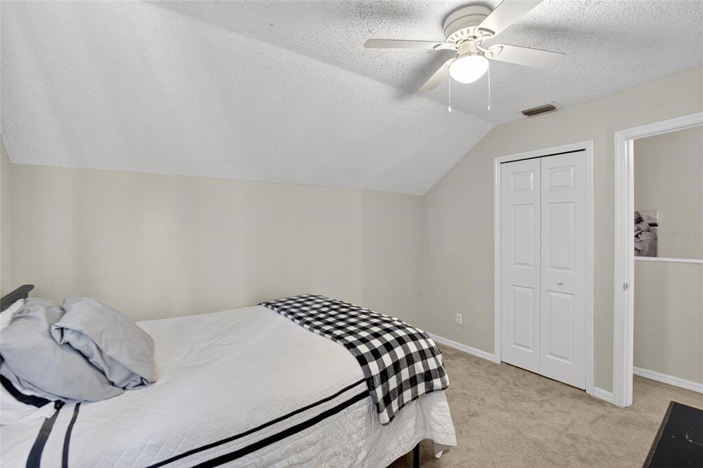 630 Cape Cod Circle Valrico, FL 33594 - Photo 32 of 48 a bedroom with a bed and a chandelier