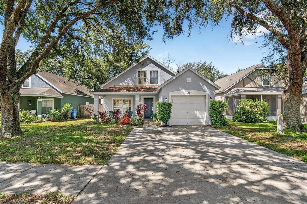 630 Cape Cod Circle Valrico, FL 33594 - Photo 42 of 48 a front view of a house with a yard and garage