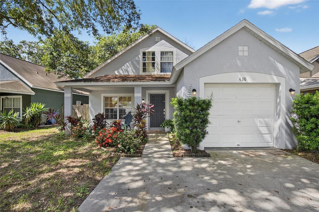 630 Cape Cod Circle Valrico, FL 33594 - Photo 6 of 48 a front view of a house with garden