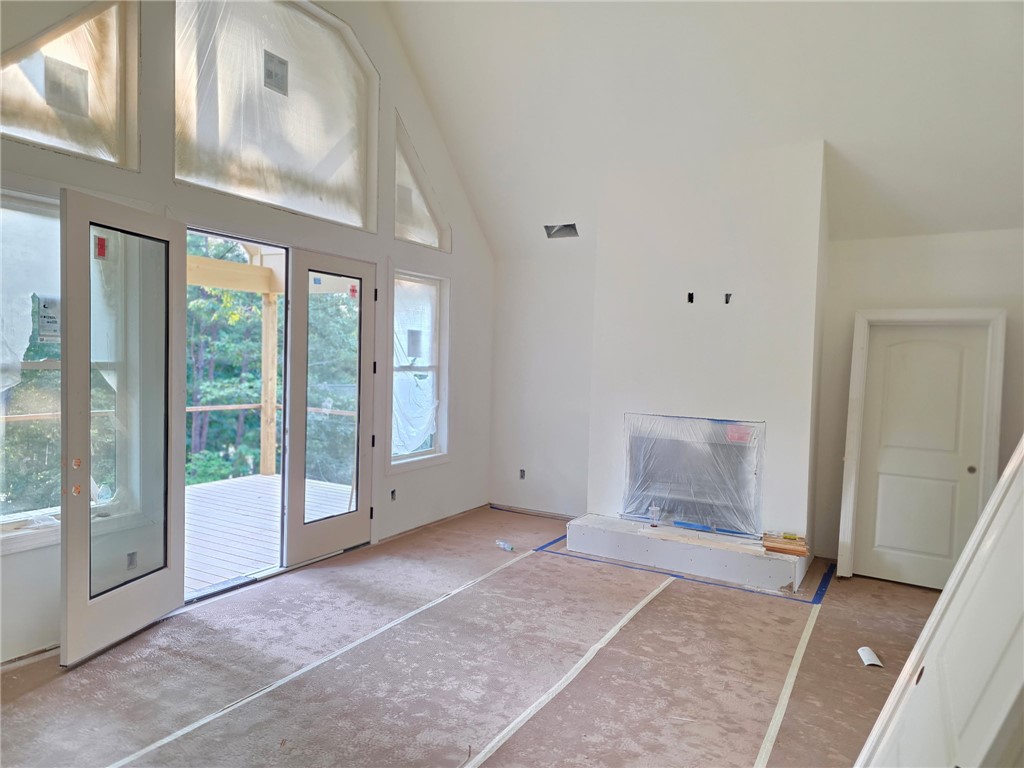 107 Abaco Lane Seneca, SC 29672 - Photo 8 of 28 A grand fireplace and high vaulted ceilings define this inviting, naturally lit living space.