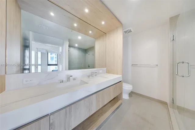 a spacious bathroom with a tub sink and mirror