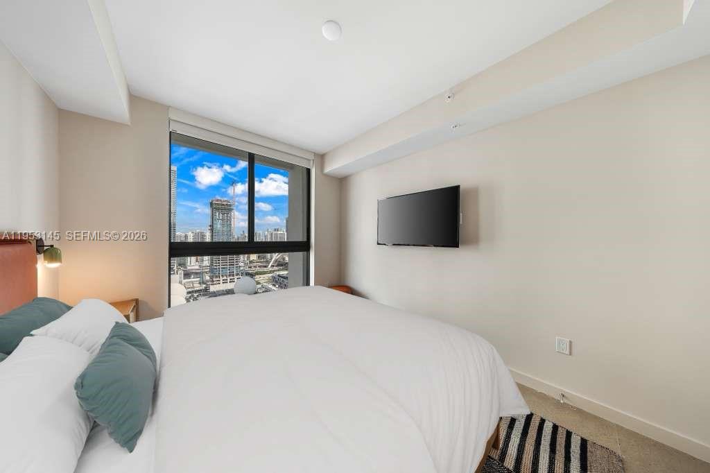 11 Northeast 6th Street, Unit 3209 Miami, FL 33132 - Photo 15 of 30 a bedroom with a bed and a flat screen tv