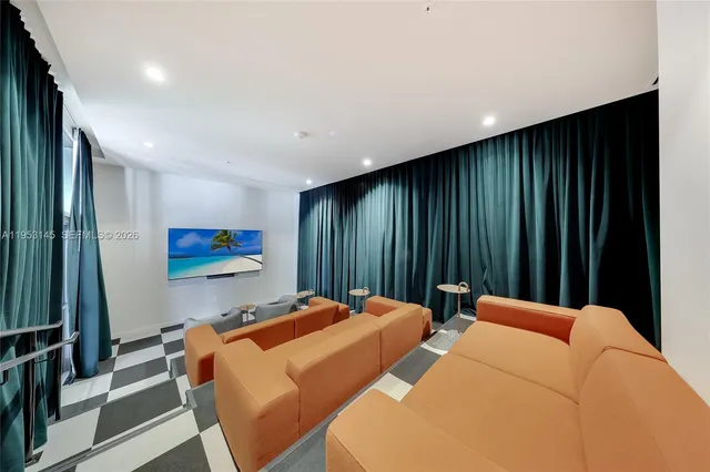a view of a hallway with a couch and a chandelier