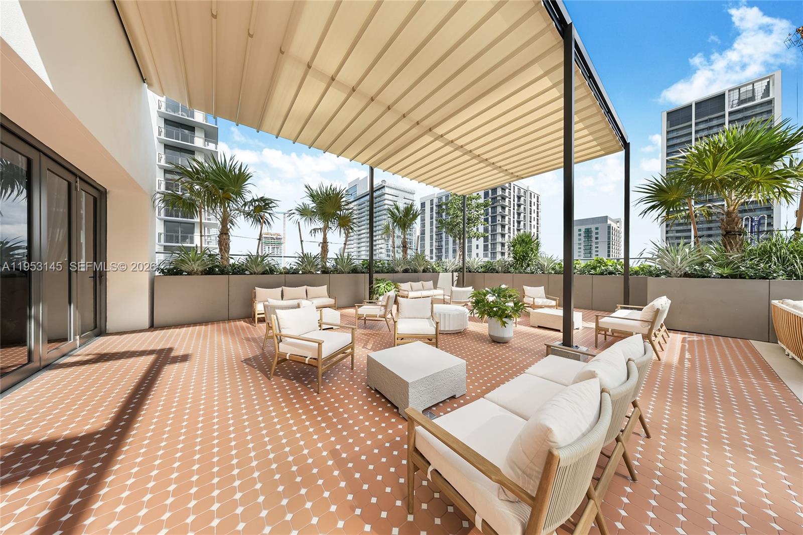 11 Northeast 6th Street, Unit 3209 Miami, FL 33132 - Photo 29 of 30 a view of a patio with couches and table and chairs and potted plants
