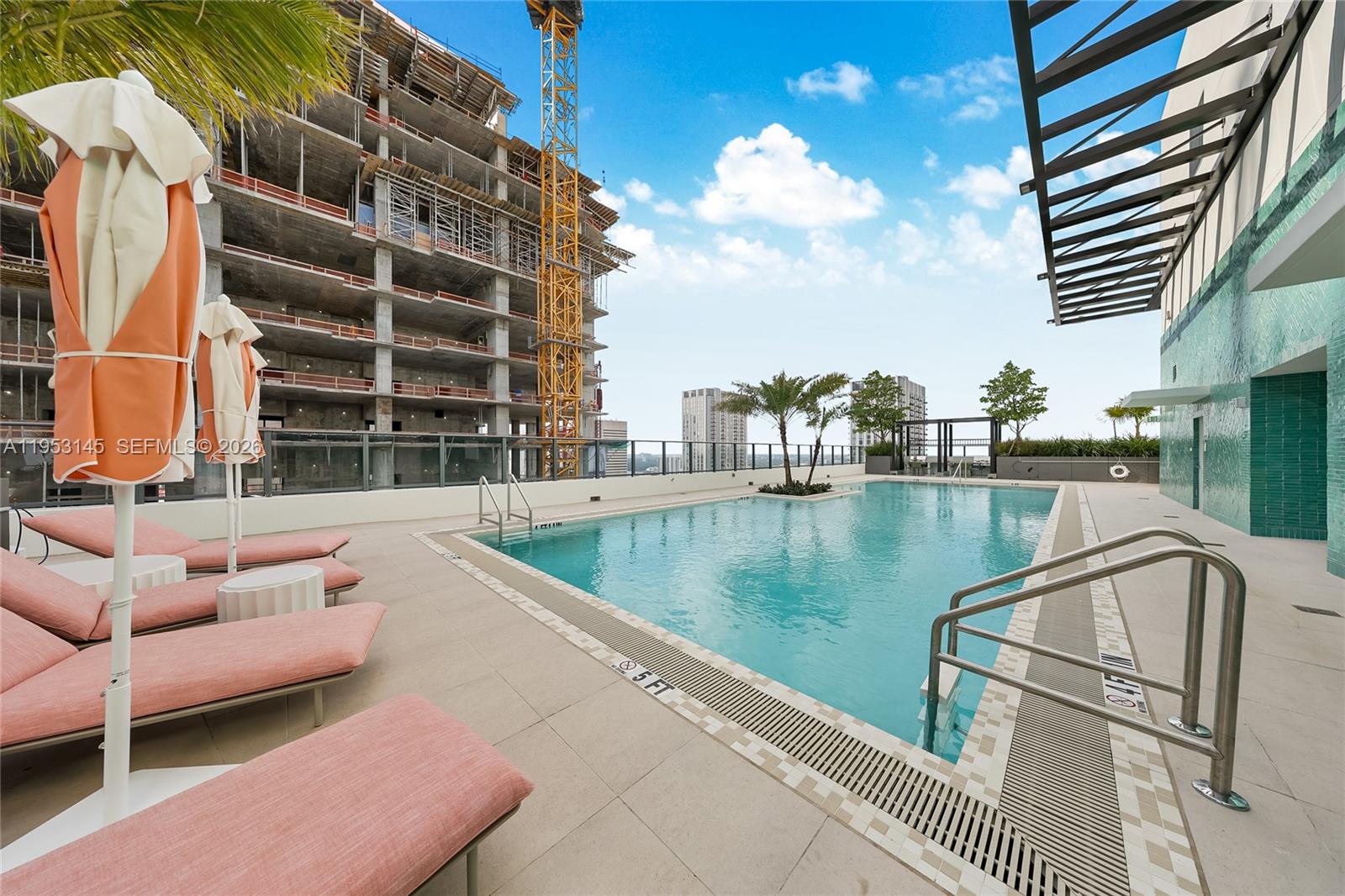 11 Northeast 6th Street, Unit 3209 Miami, FL 33132 - Photo 30 of 30 a view of a swimming pool with a couches and wooden floor