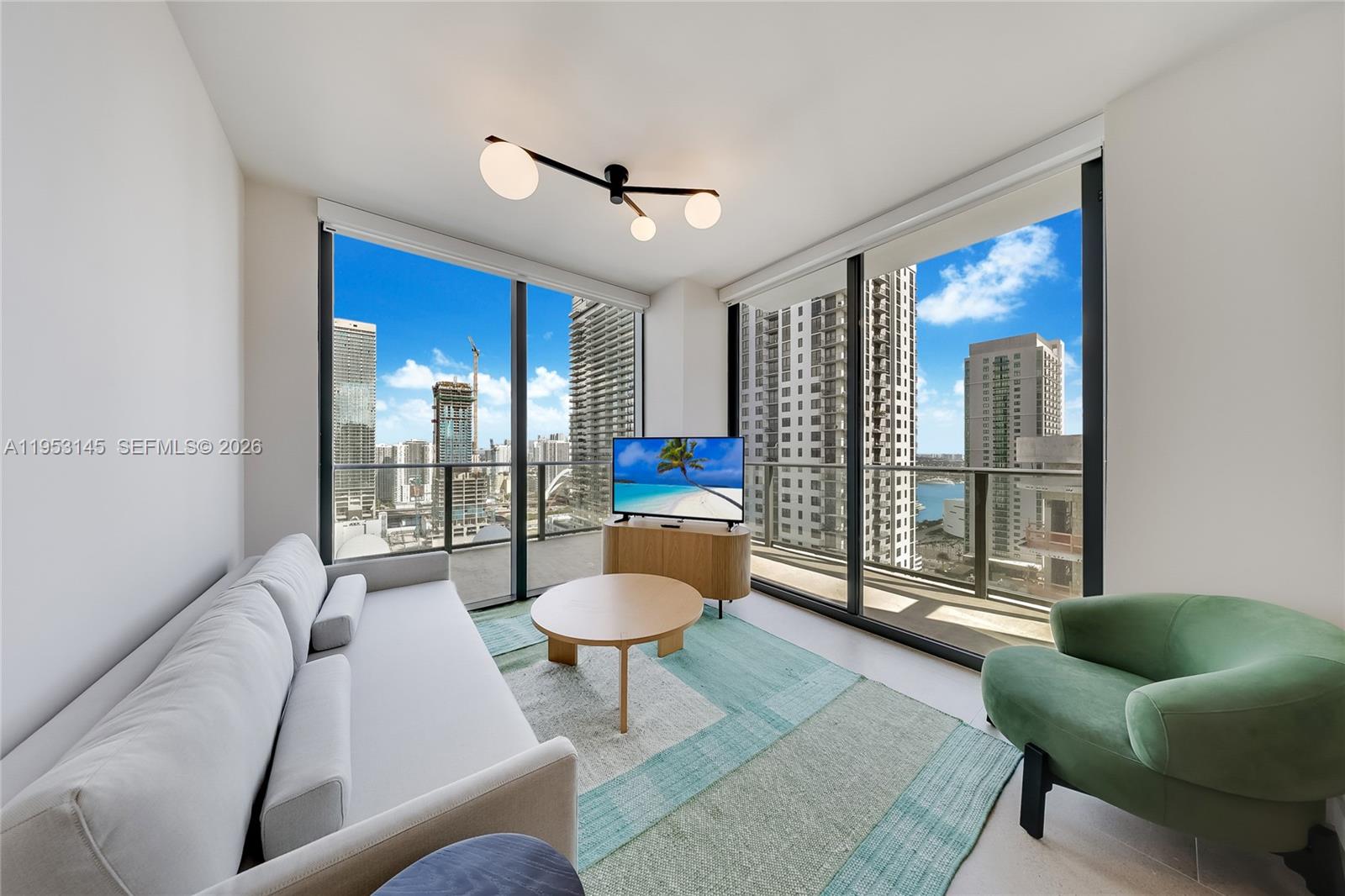 11 Northeast 6th Street, Unit 3209 Miami, FL 33132 - Photo 5 of 30 a living room with furniture and a large window