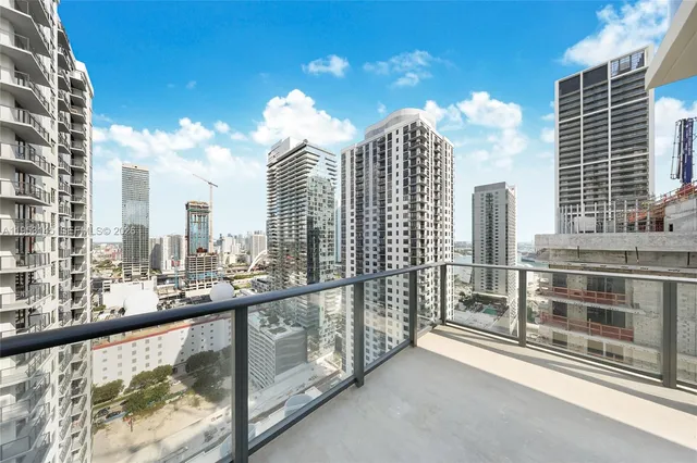 a bedroom with a bed and a dresser next to a window