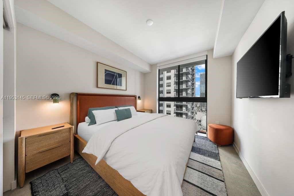 11 Northeast 6th Street, Unit 3209 Miami, FL 33132 - Photo 9 of 30 a bedroom with a bed and a flat screen tv