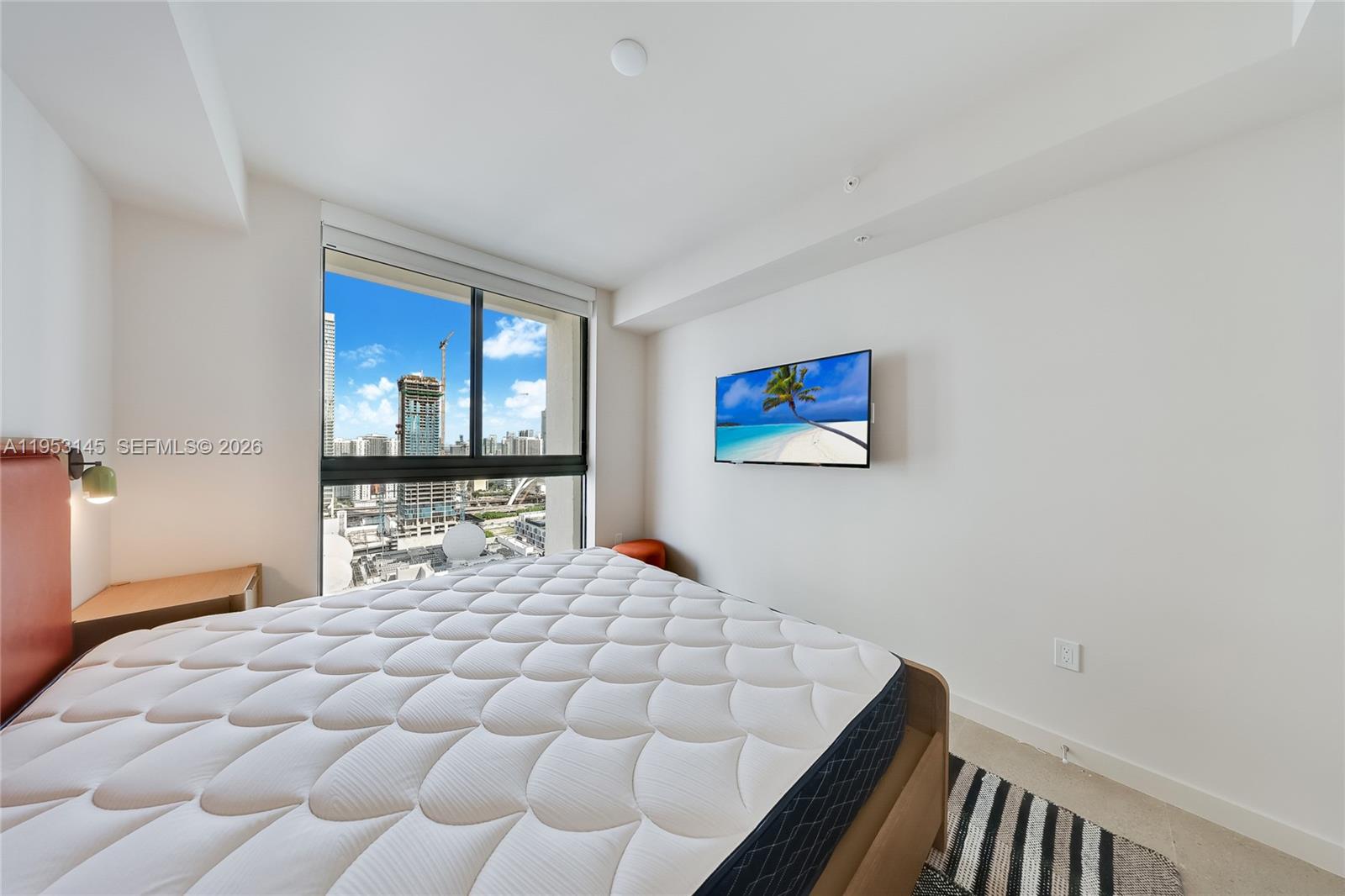 11 Northeast 6th Street, Unit 3209 Miami, FL 33132 - Photo 10 of 30 a bedroom with a large bed and a window