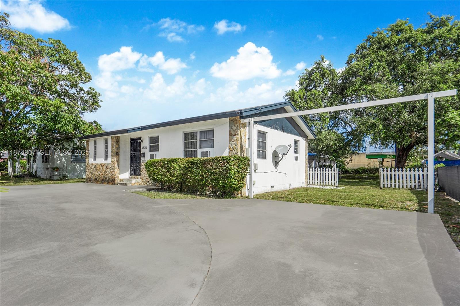 6535 Northwest 6th Avenue Miami, FL 33150 - Photo 11 of 14 a view of a house with porch and garden