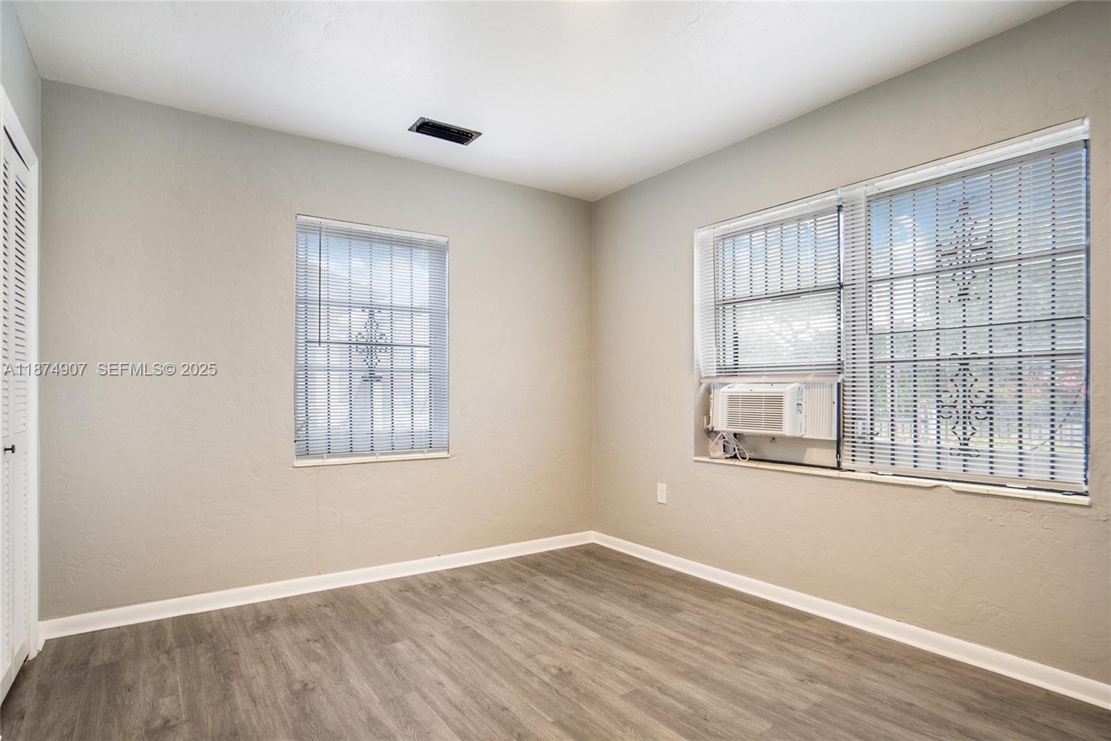 6535 Northwest 6th Avenue Miami, FL 33150 - Photo 6 of 14 an empty room with wooden floor and windows