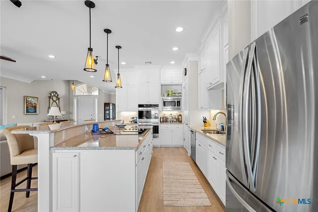 a view of living room kitchen with furniture and flat screen tv