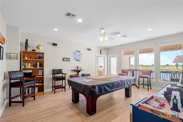 a bathroom with a granite countertop sink a toilet and a mirror