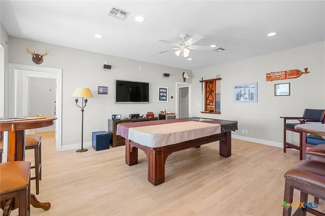 a bathroom with a granite countertop sink mirror vanity and toilet