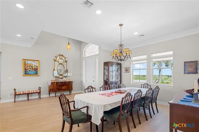 a living room with lots of furniture and a chandelier