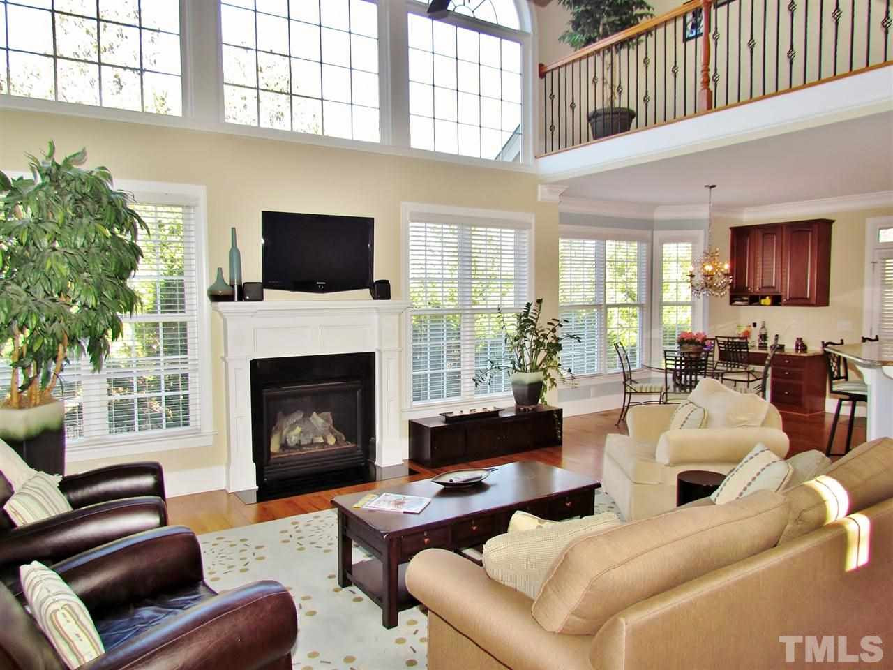 3810 Congeniality Way Raleigh, NC 27613 - Photo 7 of 25 2 story family room is light filled and welcoming. Enjoy the gas log fireplace framed by the elegant mantle. Family Room