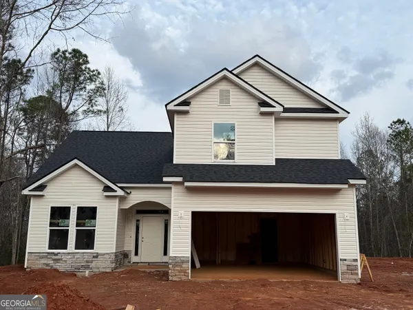 a front view of a house with yard