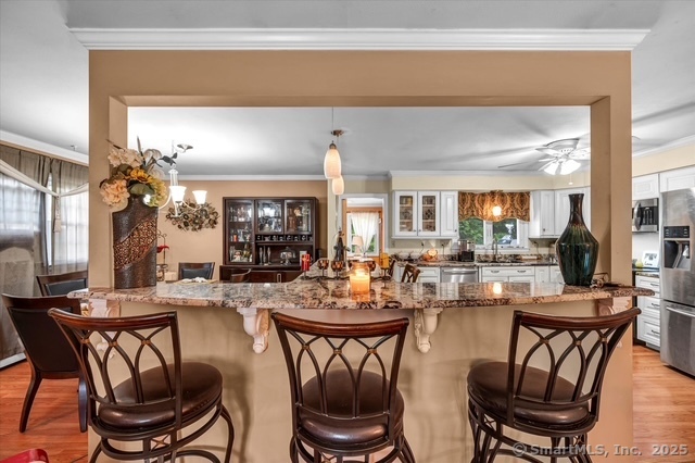 77 Oxbow Lane West Haven, CT 06516 - Photo 12 of 27 a view of a dining room with furniture and chandelier
