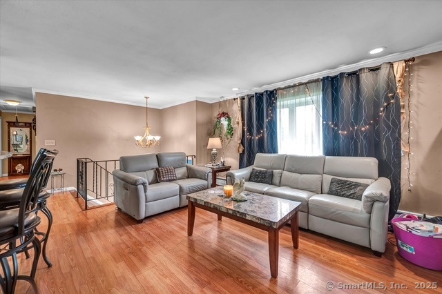77 Oxbow Lane West Haven, CT 06516 - Photo 15 of 27 a living room with furniture and a wooden floor